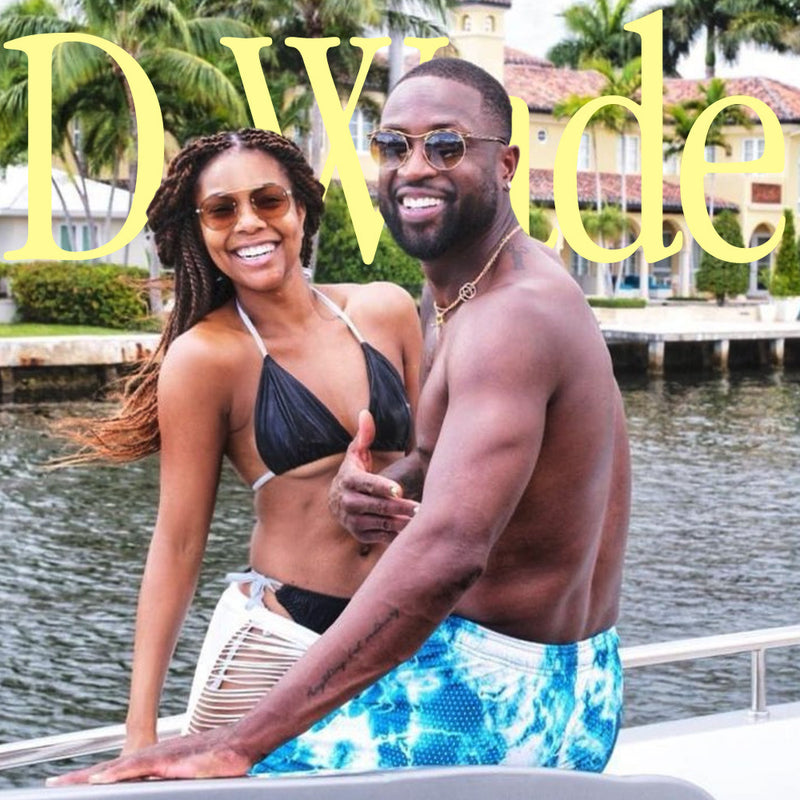 dwade with wife on boat in hoochie daddy shorts